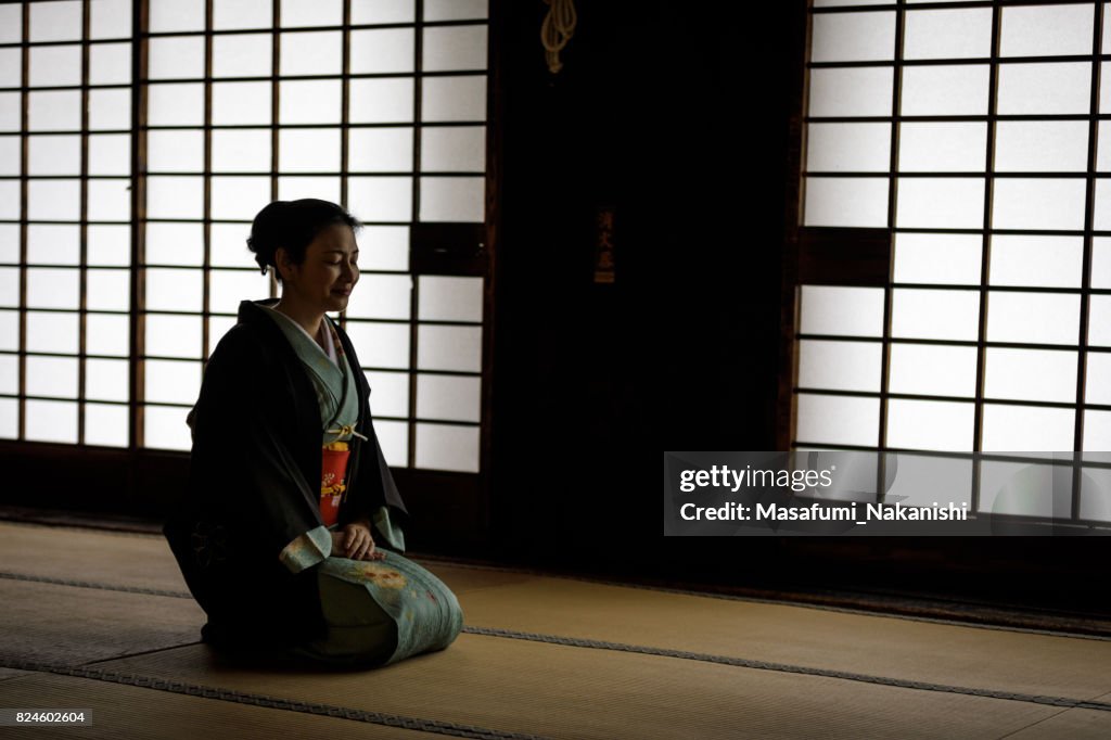 Japanese woman wearing a kimono in a Japanese style room