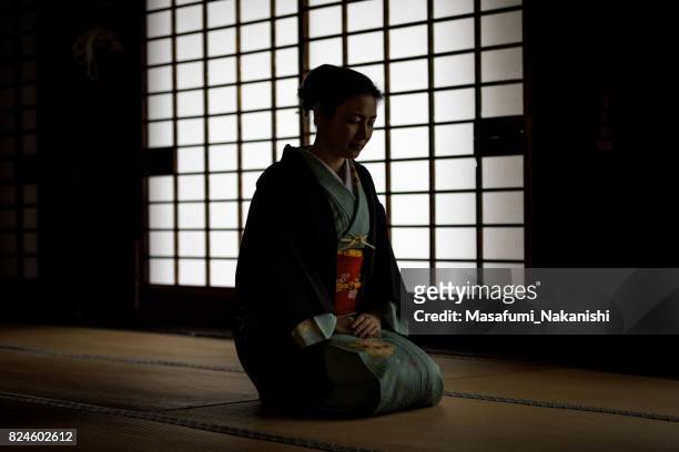 japanese woman wearing a kimono in a japanese style room - washitsu stock pictures, royalty-free photos & images
