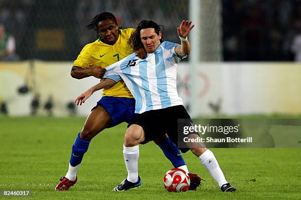 Lionel Messi of Argentina is tackled by Anderson of Brazil during the men's football semifinal match between Argentina and Brazil at Workers' Stadium...