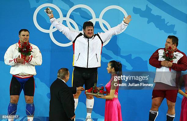 Grzegorz Kleszcz of Poland, Matthias Steiner of Germany and Viktors Scebratihs of Latvia celebrate their medals in the Men's 105 kg group...