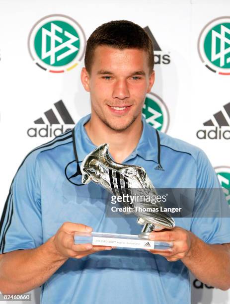 Lukas Podolski of Germany is awarded with a silver shoe, the price for the second best scorer of the UEFA EURO 2008 at the Adidas Brand Center on...