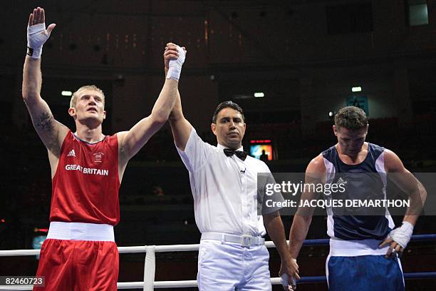 Great Britain's Tony Jeffries is declared winner after defeating Hungary's Imre Szello during their 2008 Olympic Games Light Heavyweight...