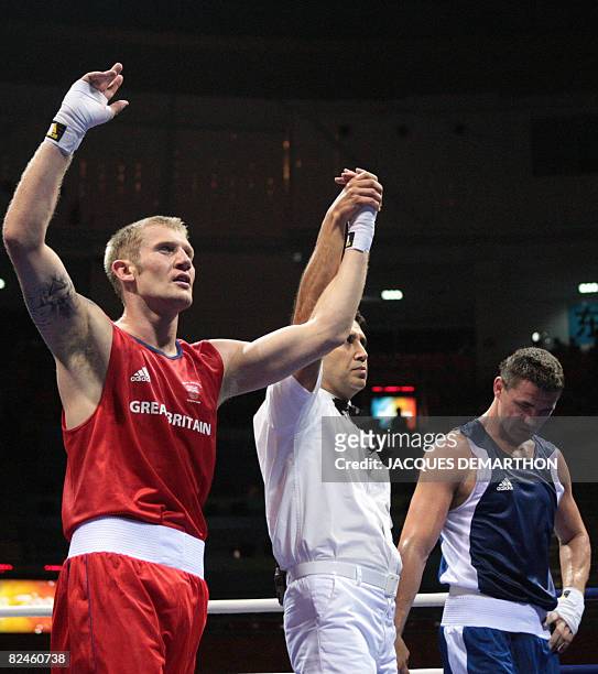 Great Britain's Tony Jeffries is declared winner after defeating Hungary's Imre Szello during their 2008 Olympic Games Light Heavyweight...