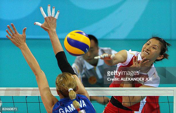 China's Yunwen Ma performs a spike in front Russia's Ekaterina Gamova during their women's quarterfinal volleyball match of the 2008 Beijing Olympic...