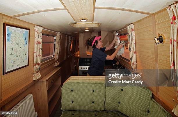 Boat builder Jane Chalker cleans the inside of a finished narrowboat as her company ABC Leisure Group prepare it for service as a canal holiday hire...