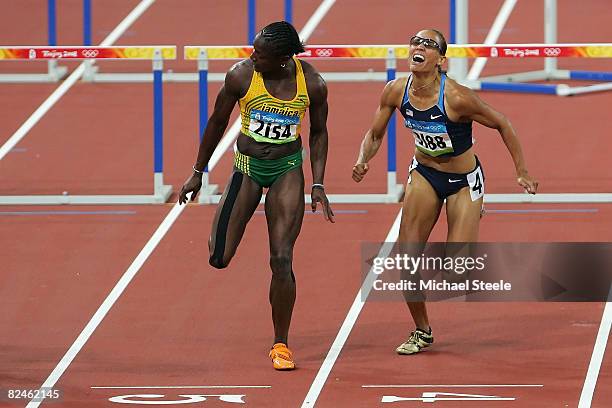 Delloreen Ennis-London of Jamaica and Lolo Jones of the United States compete in the Women's 100m Hurdles Final held at the National Stadium on Day...