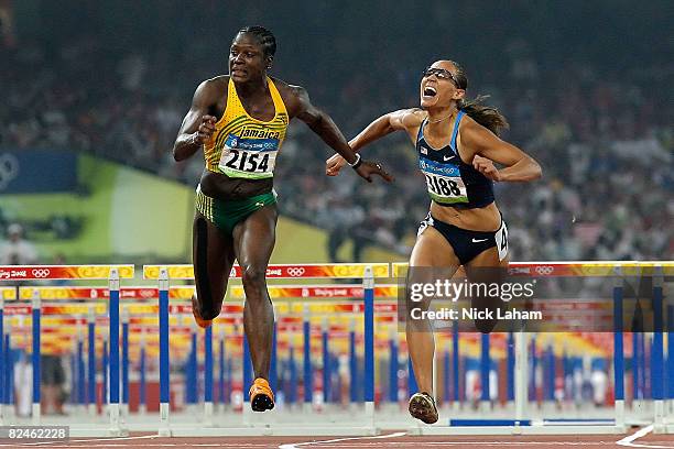 Delloreen Ennis-London of Jamaica and Lolo Jones of the United States compete in the Women's 100m Hurdles Final held at the National Stadium on Day...