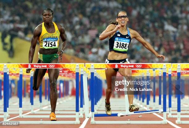 Delloreen Ennis-London of Jamaica and Lolo Jones of the United States compete in the Women's 100m Hurdles Final held at the National Stadium on Day...