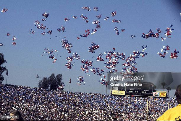 Super Bowl XI half-time performance of"It's a Small World" including crowd participation for the first time with spectators waving colored placards...