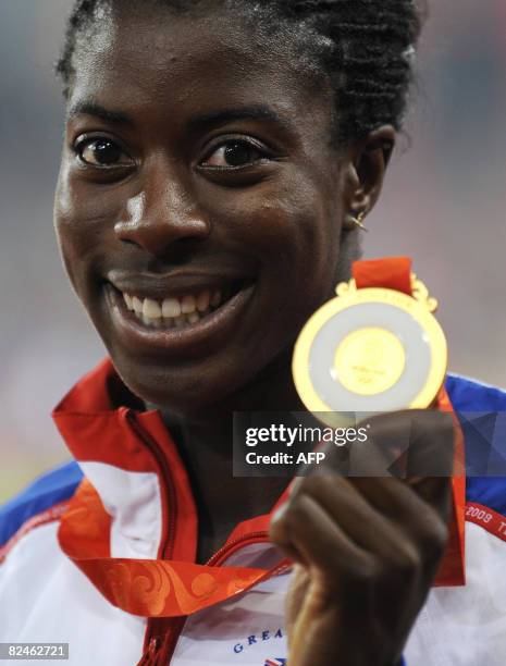 Britian's gold medalist Christine Ohuruogu poses on the podium after the women's 400m final at the "Bird's Nest" National Stadium during the 2008...