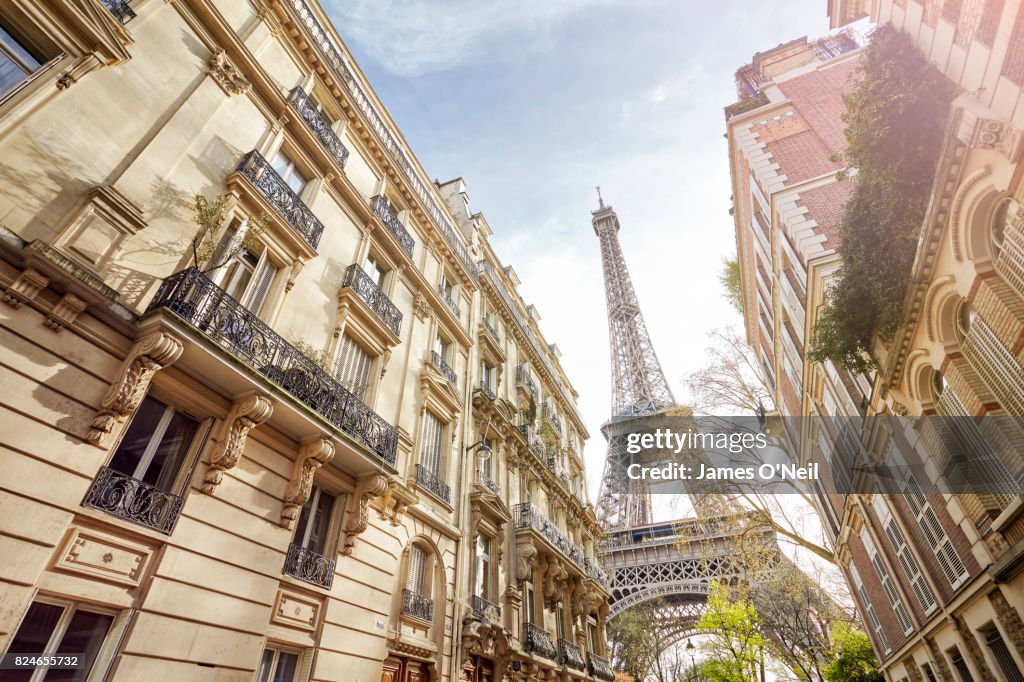 Looking up at The Eiffel Tower through Paris housing, Paris, France