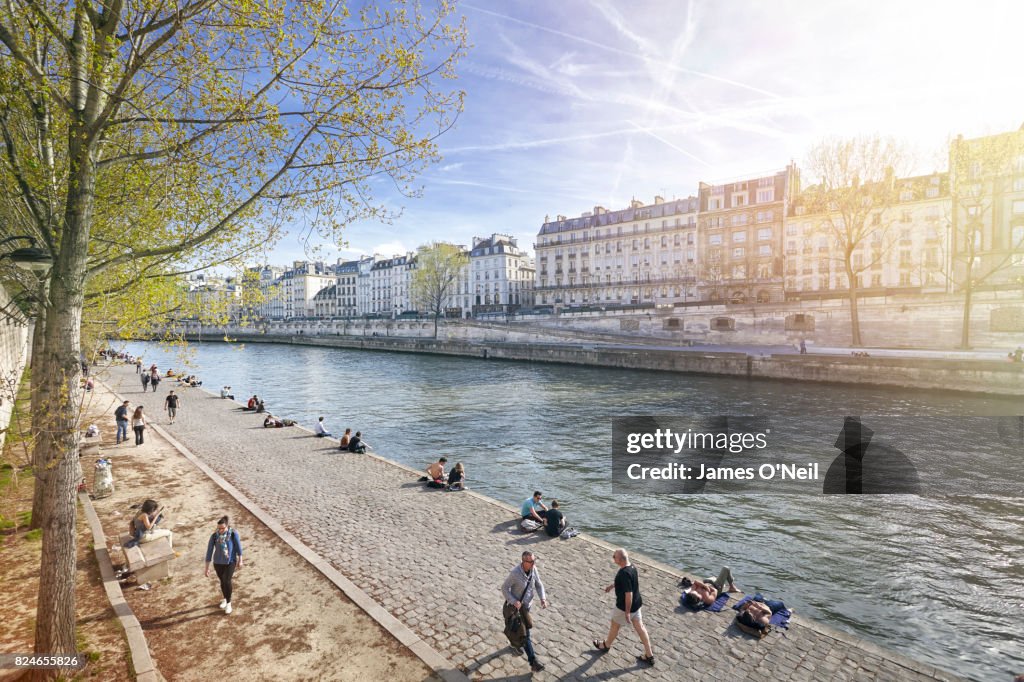 The River Seine walkway with Parisians relaxing, Paris, France