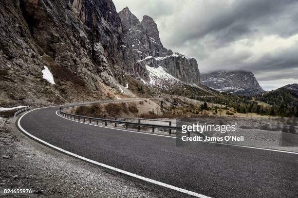 curved road in dramatic mountain range, dolomites, italy - vägräcke bildbanksfoton och bilder