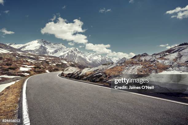 curved empty road on mountain pass, san bernardino, switzerland - bergstrasse stock-fotos und bilder