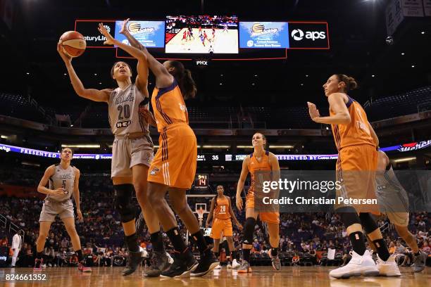 Isabelle Harrison of the San Antonio Stars attempts a shot over Angel Robinson of the Phoenix Mercury during the second half of the WNBA game at...