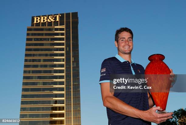 John Isner poses with the trophy after winning the BB&T Atlanta Open at Atlantic Station on July 30, 2017 in Atlanta, Georgia.
