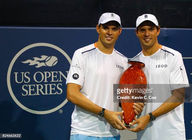 Bob and Mike Bryan pose with the trophy after winning the BB&T Atlanta Open at Atlantic Station on July 30, 2017 in Atlanta, Georgia.