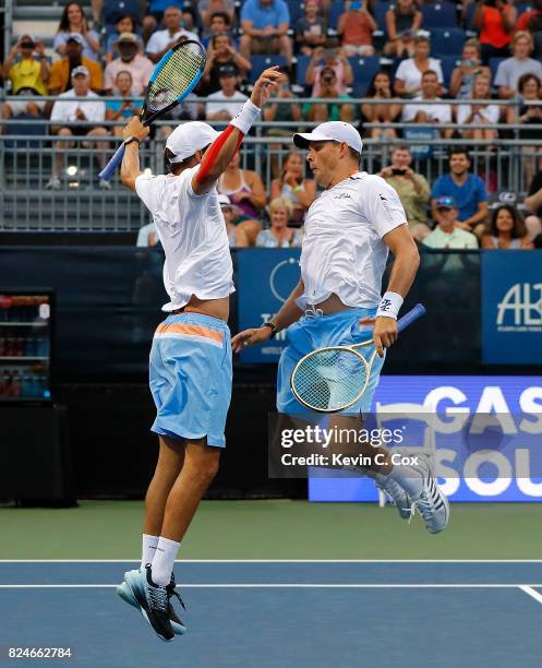 Bob and Mike Bryan celebrate after defeating the Wesley Koolhof of the Netherlands and Artem Sitak of New Zealand during the BB&T Atlanta Open at...