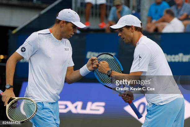 Bob and Mike Bryan react during the match against Wesley Koolhof of the Netherlands and Artem Sitak of New Zealand during the BB&T Atlanta Open at...