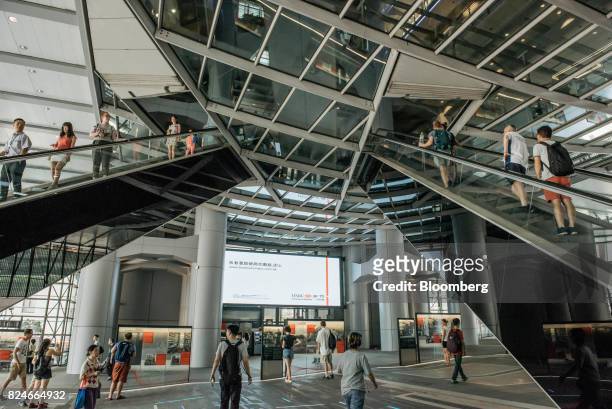 People ride on escalators at the HSBC Holdings Plc headquarters building in Hong Kong, China, on Saturday, July 29, 2017. HSBC is set to announce...