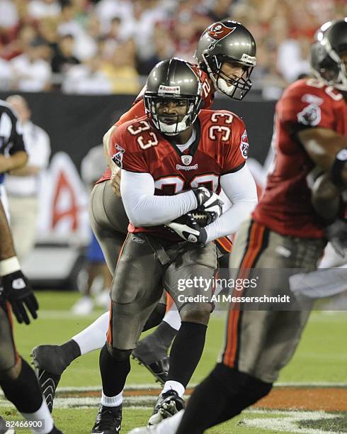 Running back Kenneth Darby of the Tampa Bay Buccaneers rushes upfield against the New England Patriots at Raymond James Stadium on August 17, 2008 in...