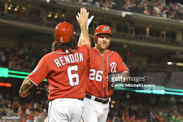 Adam Lind of the Washington Nationals celebrates a two run home run with Anthony Rendon in the fifth inning during game two of a doubleheader against...