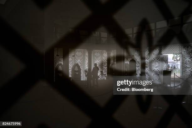 Visitors pray at the Crystal Mosque in Kuala Terengganu, Terengganu, Malaysia, on Monday, July 23, 2017. With a federal election due within 12...