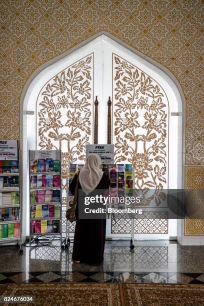 Visitor browses religious reading materials at the Crystal Mosque in Kuala Terengganu, Terengganu, Malaysia, on Monday, July 23, 2017. With a federal...