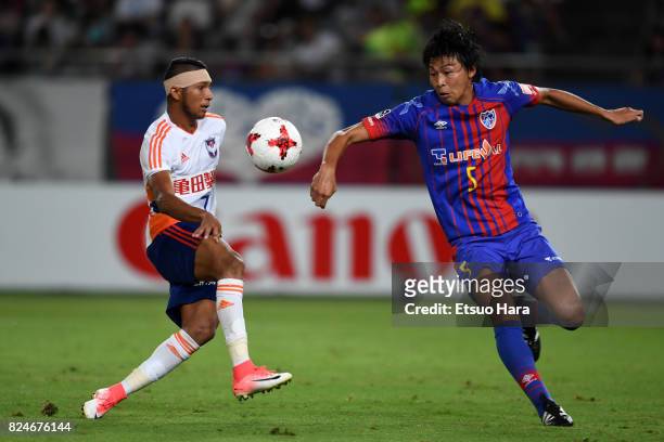 Rony of Albirex Niigata and Yuichi Maruyama of FC Tokyo compete for the ball during the J.League J1 match between FC Tokyo and Albirex Niigata at...