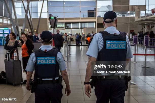 Australian Federal Police Officers patrol Sydney Airport on July 31, 2017 in Sydney, Australia. Counter terrorism police raided four houses across...