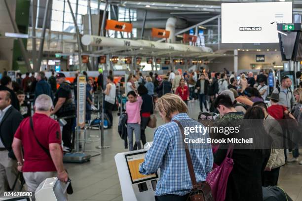 Passangers at Sydney Airport face a long wait to clear security on July 31, 2017 in Sydney, Australia. Counter terrorism police raided four houses...