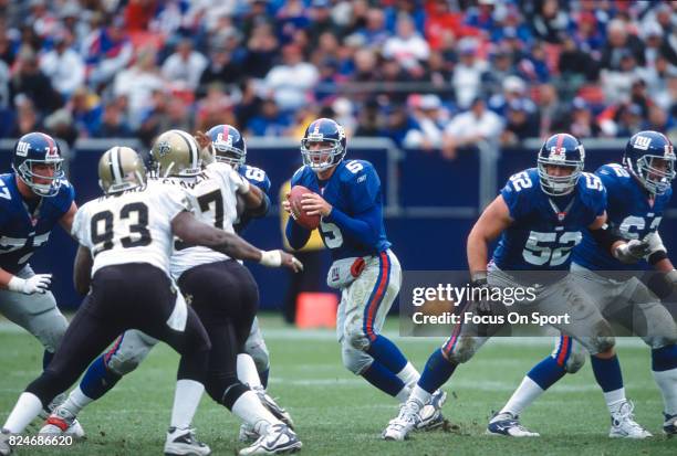 Kerry Collins of the New York Giants drops back to pass against the New Orleans Saints during an NFL game September 30, 2001 at Giant Stadium in East...