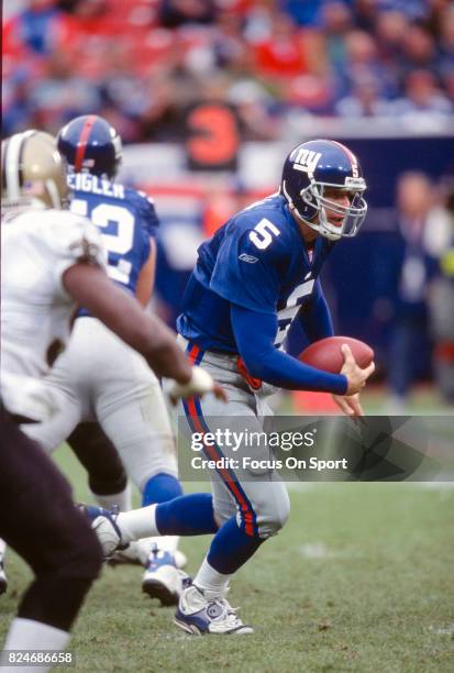 Kerry Collins of the New York Giants runs with the ball against the New Orleans Saints during an NFL game September 30, 2001 at Giant Stadium in East...