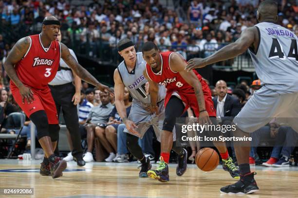 Trilogy guard James White dribbles as Ghost Ballers guard Mike Bibby and forward Ivan Johnson defend during the Big3 basketball game between the...