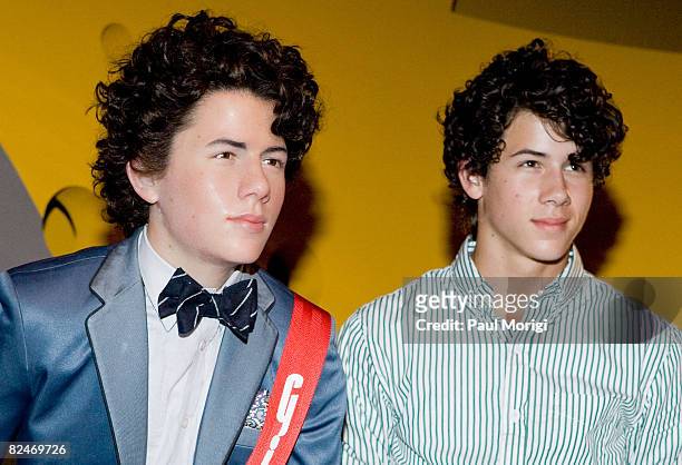 Nick Jonas standing next to his wax likeness at the unveiling of the Jonas Brothers Wax Figures at Madame Tussauds on August 18, 2008 in Washington,...