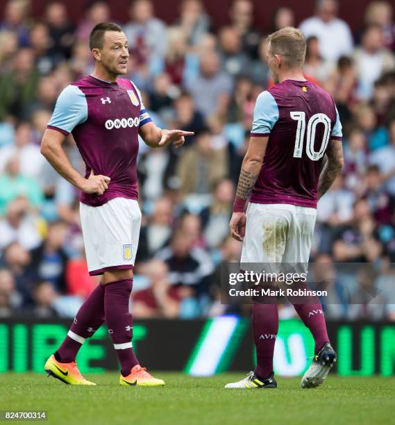 John Terry of Aston Villa talks to his team mate Glenn Whelan during the match between Aston Villa and Watford at Villa Park on July 29, 2017 in...