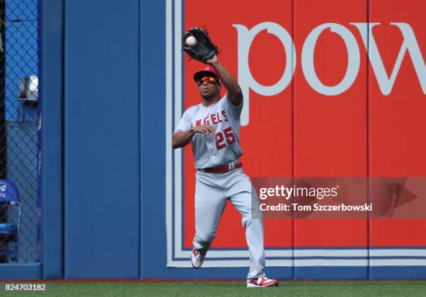 Ben Revere of the Los Angeles Angels of Anaheim catches a fly ball in the eighth inning during MLB game action against the Toronto Blue Jays at...