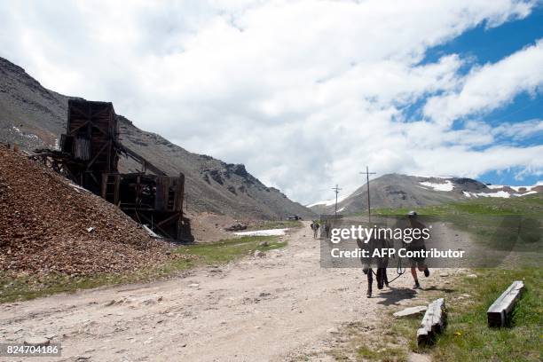 George Zack of Broomfield, Colorado and his burro Jack run past the North London Mine after racing over Mosquito Pass during the 69th Annual Burro...