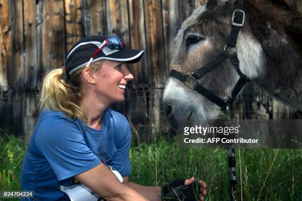 Amy Holtschlag of Conifer, Colorado poses for a portrait with her burro Mr. Ziffel before running in the Pack Burro Race during the 69th Annual Burro...