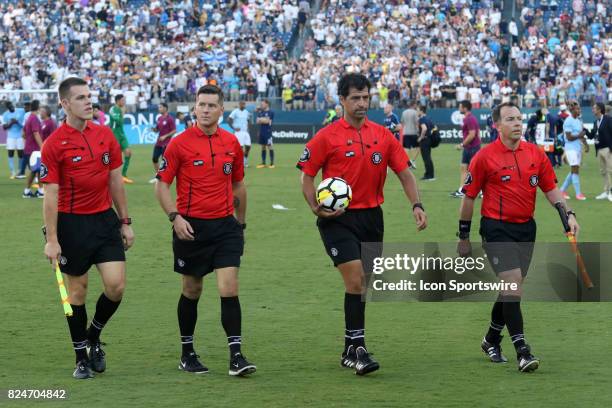 The referees leave the field after the game between Manchester City and Tottenham Hotspur. Manchester City defeated Tottenham by the score of 3-0....