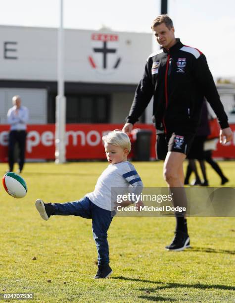 Nick Riewoldt watches son James kick a football after he announces his retirement during a St Kilda Saints AFL press conference at Linen House Oval...