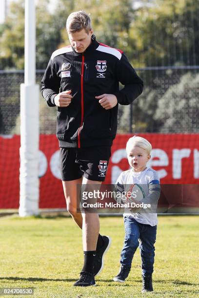 Nick Riewoldt watches his son James run with a football after he announces his retirement during a St Kilda Saints AFL press conference at Linen...