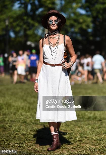 Festival goer is seen wearing a white dress, brown belt and brown boots during the 2017 Panorama Music Festival Day 3 at Randall's Island on July 30,...