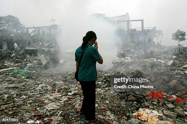 Mother grieves for her son who died in the Sichuan earthquake among the debris of the Beichuan Middle School on August 19, 2008 in Beichuan County,...