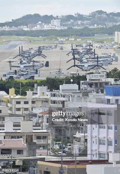 Photo taken in May 2017 shows a densely populated downtown area of Ginowan in Okinawa Prefecture, with U.S. Marine Corps Air Station Futenma in the...