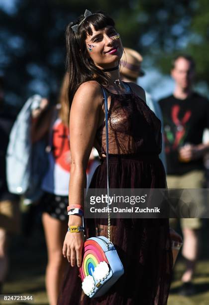 Festival goer is seen wearing a sheer burgandy dress with rainbow bag during the 2017 Panorama Music Festival Day 3 at Randall's Island on July 30,...