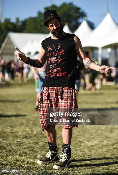 Festival goer is seen wearing Comme Des Garcons plaid shorts and Rick Owens sneakers during the 2017 Panorama Music Festival Day 3 at Randall's...