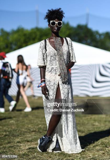 Festival goer is seen wearing a white sheer floral dress with white sunglasses during the 2017 Panorama Music Festival Day 3 at Randall's Island on...