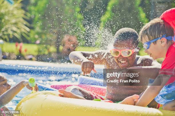 children playing in the pool - kids pool games stock pictures, royalty-free photos & images