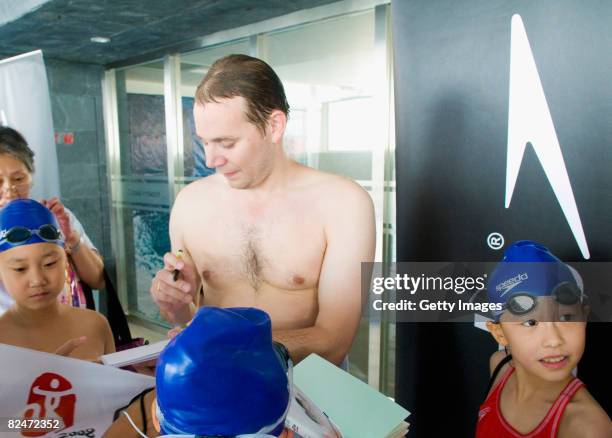 James Hickman signs autographs at the Speedo Stars of Tomorrow swimming clinic in the Ozone Pool on August 20, 2008 in Beijing, China.